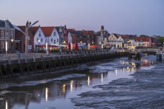 Buildings at the harbour, skyline, low tide, illuminated, blue hour, Husum, North Sea, North