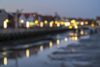 Buildings at the harbour, skyline, illuminated, blue hour, blurred, Husum, North Sea, North Frisia,