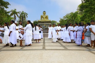 Pilgrims in front of a Buddha statue, Colombo, Sri Lanka