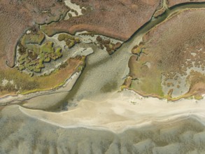 Marshes and streams at low tide in the Walvis Bay Lagoon. Aerial view. Drone shot. Namibia
