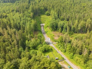 An extensive forest landscape with a railway line and a tunnel, construction of the Hermann Hesse
