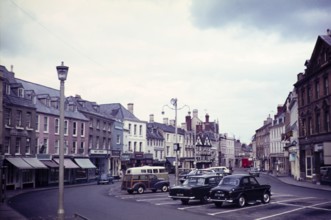 Cars parked in Market Place square, town of Cirencester, Gloucestershire, England, UK 1960s