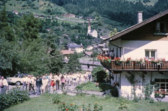People in street procession through village of Oetz, Imst district, Tyrol, Austria, Europe, 1970