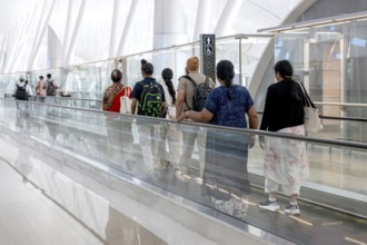 Airport moving walkway Passengers with hand luggage, Abu Dhabi, United Arab Emirates