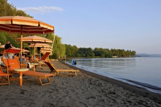 Beach, deckchairs, sunshades at the lido, Lake Bolsena, Lago di Bolsena, volcanic crater lake, calm