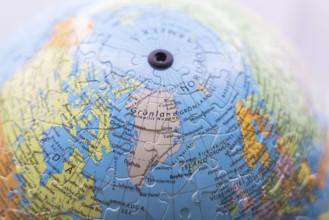 Puzzle globe. Map made from puzzle pieces. Greenland and Denmark