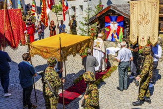 The priest celebrates a service at the flower-decorated altar during the Corpus Christi procession,