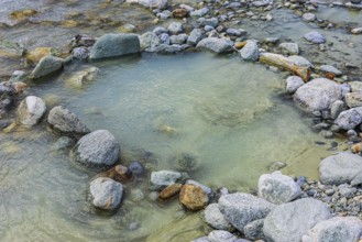 Boulders form a circle in the mountain stream La Navisence, near Zinal, Val d'Anniviers, Valais