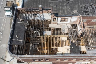 Detroit, Michigan - Workers rehab a long-vacant and crumbling commercial building in the