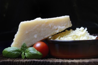 Parmesan cheese, grated cheese in rind and piece of Parmesan, Italy