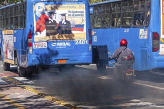 Buses in motion emitting pollution, City of Quito. Pichincha province, Ecuador, South America