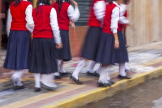 Group of female students walking to the college, Motion blur, City of Otavalo, Imbabura province,