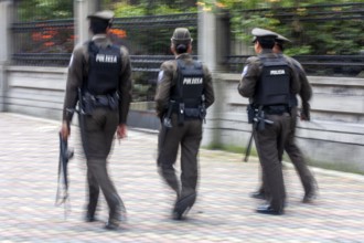 Policemen walking in the street, Motion blur, City of Quito. Pichincha province, Ecuador, South