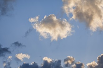 Black and white clouds in the blue evening sky