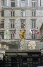 Count Peter of Savoy golden figure above entrance to The Savoy hotel, Strand, central London,