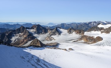 Narrow rocky ridge at the Wilder Freiger summit, picturesque high mountain landscape with snow,