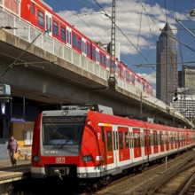 Two regional express trains on different levels at Frankfurt West station with Messeturm, Frankfurt