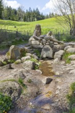 Figure of the river god Danuvius by sculptor Wolfgang Eckert at the source of the Breg, source of