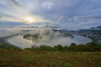 Misty river landscape in the morning light, surrounded by hills and clouds, summer, Rhine bend