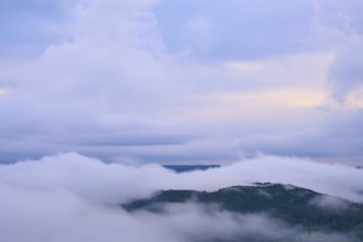 Dense fog over a hilly landscape with colourful morning sky and clouds, summer, Rhine bend Boppard,