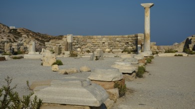 Historical site with remains of columns and detailed stone blocks in the open air, Agios Stefanos