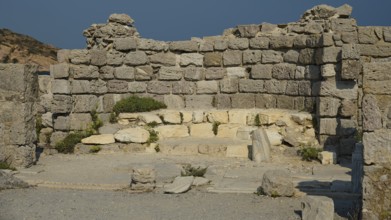 Stone ruins with ancient walls standing under the sun, Agios Stefanos Beach, Agios Stefanos