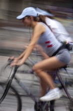 Women riding on bicycles, Photo with motion blur, City of Quito, Pichincha province, Ecuador, South