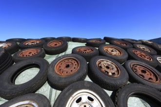 Old wheels, rims and tyres, used here to weigh down the cover of an agricultural silo