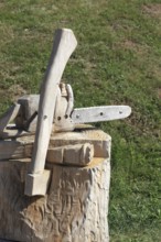 Chainsaw and axe carved from wood as decoration