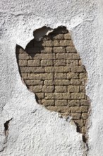 Building damage, wall damage, flaking plaster and wall paint, bricks