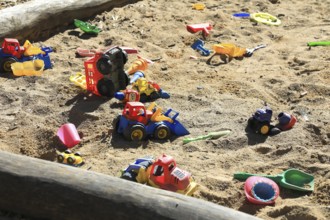 Playground, sandpit with plastic toys, vehicles, shovel