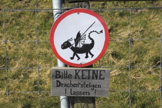 Humour, sign Please do not fly kites, on a dyke near Westerhever on the North Sea, North Frisia,
