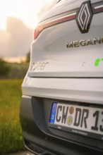Rear view of a Renault with licence plate and sunlight in the background, Deer E- CarSharing,