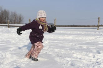 Girl running in the snow, Allgäu, Bavaria, Germany, Allgäu, Bavaria, Germany