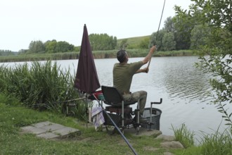 Fisherman, Angler casting a line at a lake, Southern Hungary, Hungary, Southern Hungary, Hungary
