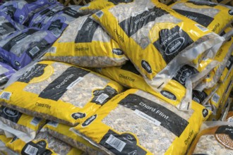 Chard Flint stone chippings bags stacked up at Lowden garden centre, Wiltshire, England, UK