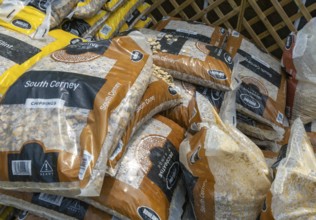 South Cerney stone chippings bags stacked up at Lowden garden centre, Wiltshire, England, UK