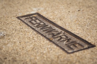 Sign for district heating on a manhole cover in Wuppertal, Germany