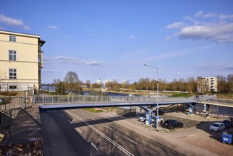 Pedestrian bridge, river Elbe, lantern, general architecture, bare wintry trees, blue sky, cumulus