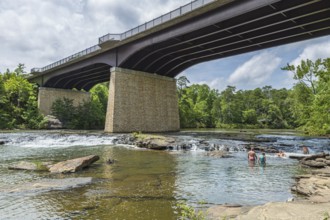 People playing on the rocks under the Little River Falls Bridge in Little River Canyon Falls Park