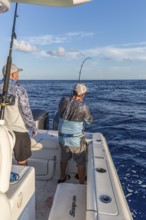 Offshore fisherman reeling in a fish in the Gulf of Mexico