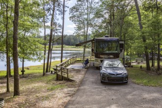 Motorhome parked in a campsite on the bank of the lake at Little Black Creek campground near