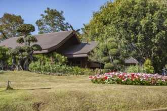 Ornate trees and lush flower gardens enhance the Lanna and Swiss architecture of the Doi Tung Royal