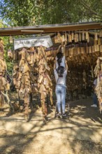 Thai women hanging their personal message plaque near the entrance to the Akha Cottage restaurant
