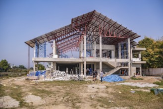 American men entering jobsite while volunteering to help build the Grace Language School and Baan