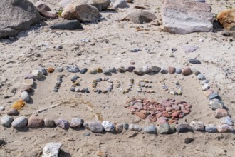 I Love You with heart on the beach with stones in the sand