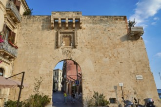 Historic stone city gate with visible road through the arch, Ortigia Island, Isola di Ortigia,