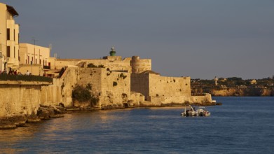 Castello Maniace, Maniace sea fortress, Mediterranean landscape with historic buildings and boat in