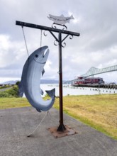 Fish sculpture in front of the Astoria Megler Bridge on the Columbia River, Astoria, Oregon, USA,