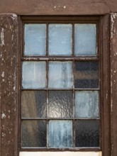 Old window with weathered wooden frame and frosted glass, reflects light, Bad Bergzabern, Southern